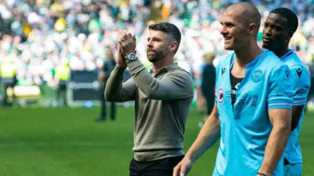 St Mirren manager Stephen Robinson applauds the visiting fans