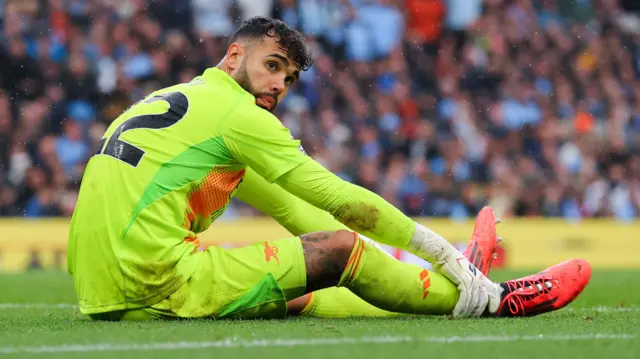 Arsenal goalkeeper David Raya sits on the floor awaiting medical treatment 