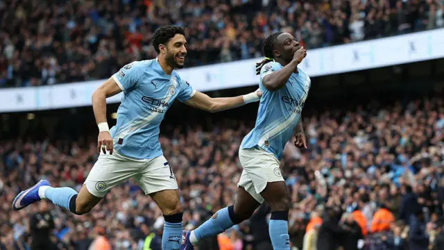 Jeremy Doku celebrates with Omar Marmoush