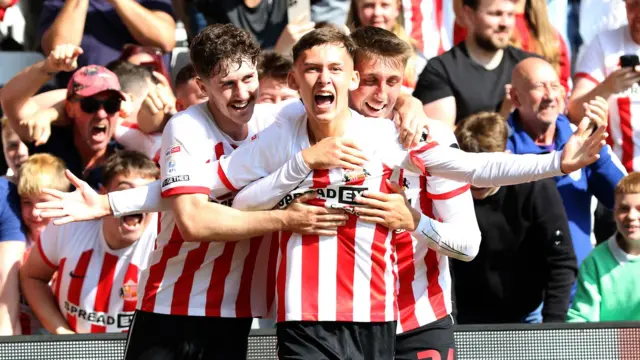 Chris Rigg celebrates with Trai Hume and Dan Neil