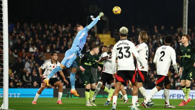 Goalkeeper Leno punches the ball away