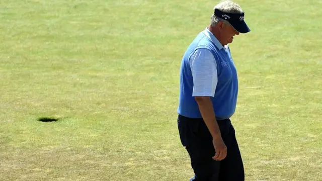 Colin Montgomerie walks on the green