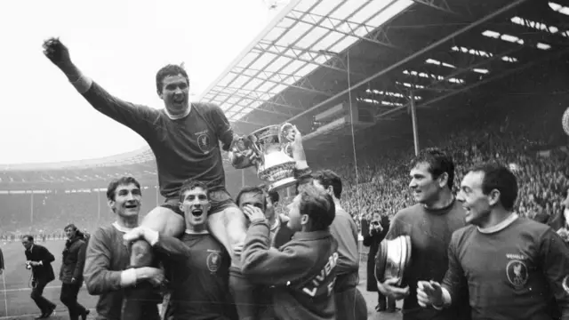 Ron Yeats is lifted up by his Liverpool team-mates after the FA Cup final victory over Leeds United in 1965