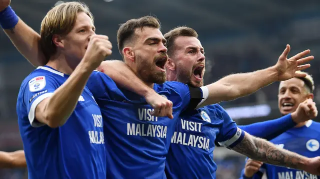 Dimitrios Goutas (centre) celebrates scoring for Cardiff against Swansea