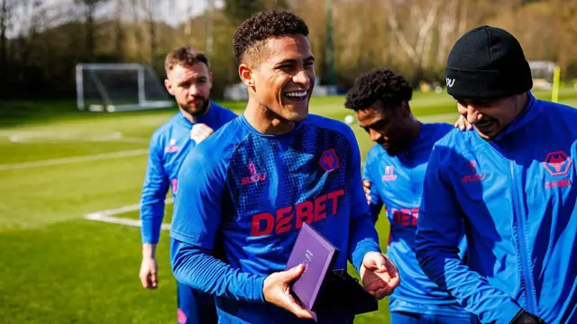 Joao Gomes of Wolves with an award for making 100 appearances in the Premier League