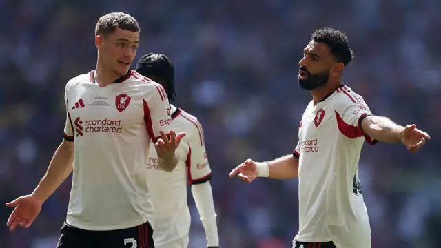 Mohamed Salah of Liverpool speaks with Florian Wirtz during the Community Shield