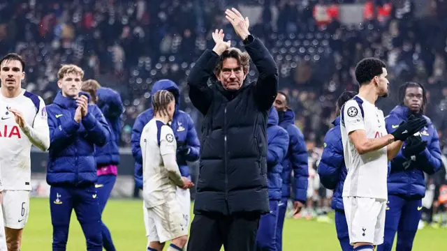 Thomas Frank applauds the Spurs fans and celebrates with his players