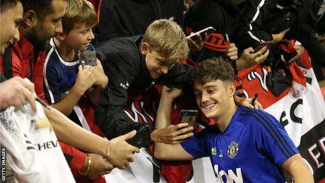 Daniel James poses with fans