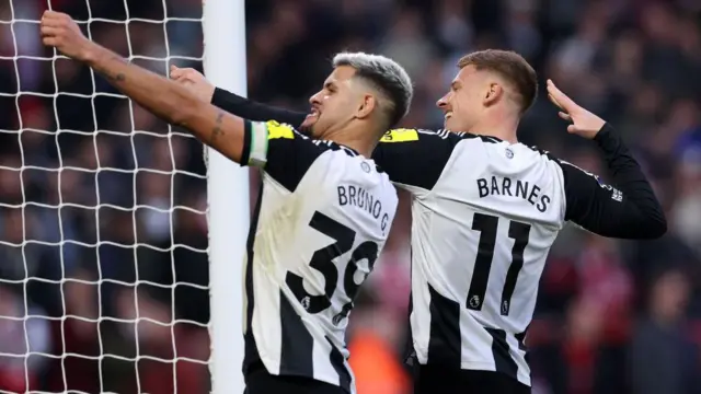 Harvey Barnes of Newcastle United celebrates scoring his team's third goal with team-mate Bruno Guimaraes