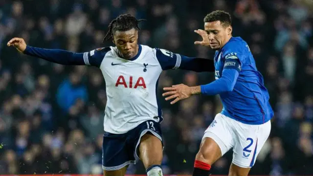 Rangers' James Tavernier (R) and Tottenham's Destiny Udogie