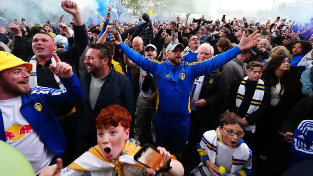 Leeds United fans celebrate outside Elland Road after winning promotion to the Premier League