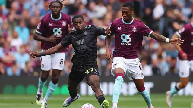 Jaidon Anthony is challenged by Noah Sadiki during the Premier League match between Burnley and Sunderland at Turf Moor