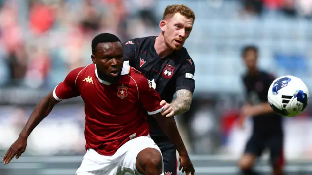 Lewis O'Brien competes for possession during Wrexham's friendly with Wisla Krakow