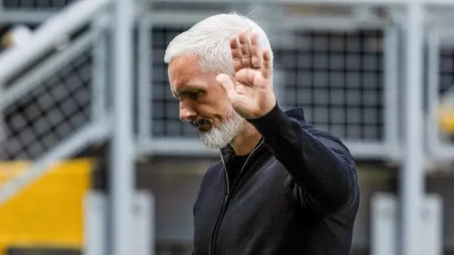 Jim Goodwin holds up a hand of apology