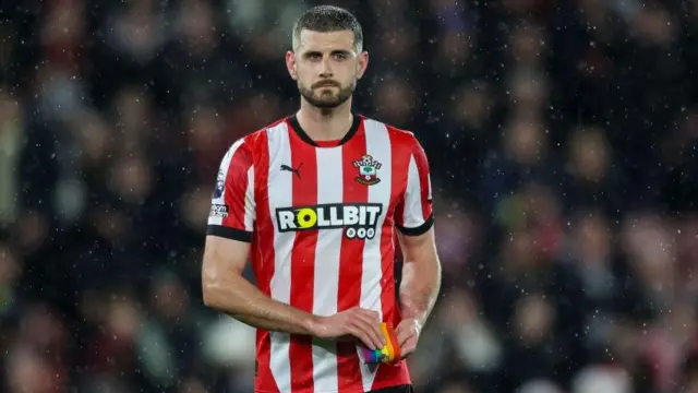 Jack Stephens walks off the field after being sent off against Chelsea