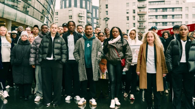 Arsenal fans, campaigners and two players on a walk to mark the No More Red initiative