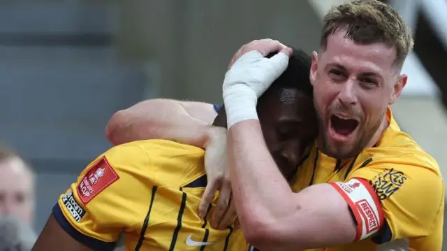 Danny Welbeck of Brighton celebrates with Adam Webster 