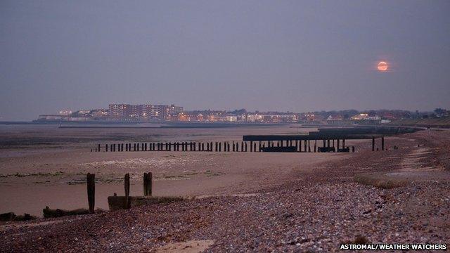 Full moon by a beach