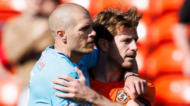 St Mirren's Alex Gogic and Dundee United's Ross Docherty hug at full time during a William Hill Premiership match between Dundee United and St Mirren at the Calforth Construction Arena at Tannadice Park