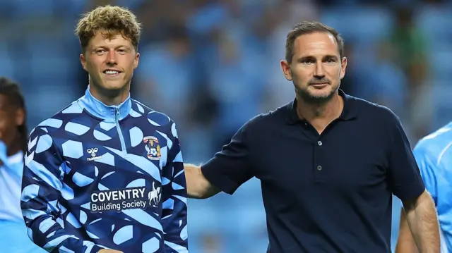 Victor Torp walks off after a game alongside Coventry City head coach Frank Lampard