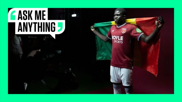 El Hadji Malick Diouf holds a Senegal flag against a black background while wearing West Ham's 2025-26 home kit. The image is framed with a green border and the words 'Ask Me Anything' in the top left corner