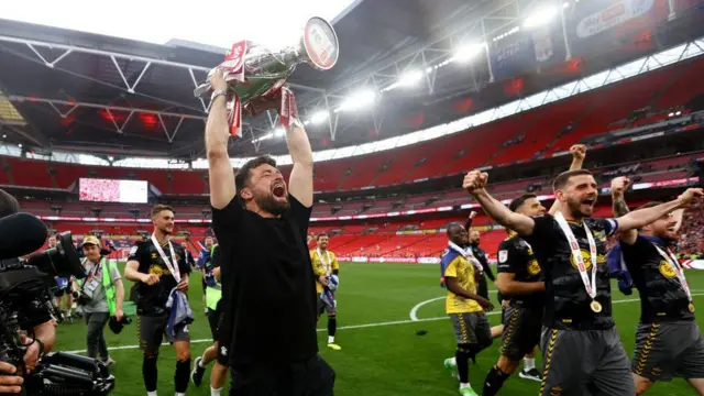 Russell Martin lifts the trophy