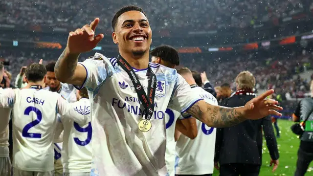 Morgan Rogers celebrates with his medal around his neck after Aston Villa's Europa League final win