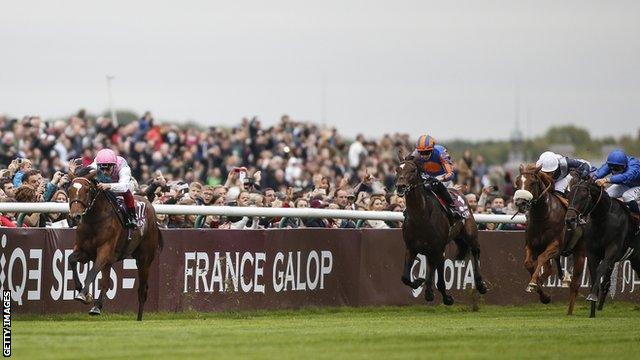 Frankie Dettori rides to the finish line on Enable