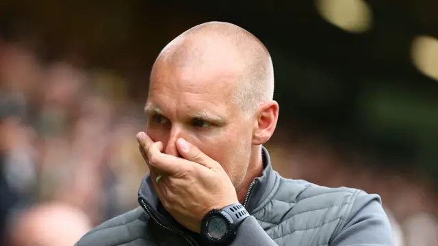 Liam Manning with his hand over his mouth