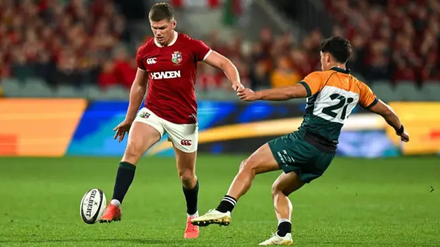 Owen Farrell kicks the ball through the AUNZ defence