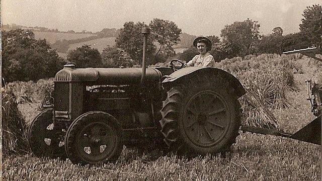 Sepia image from World War Two of Phyllis Vincent at the wheel of a tractor