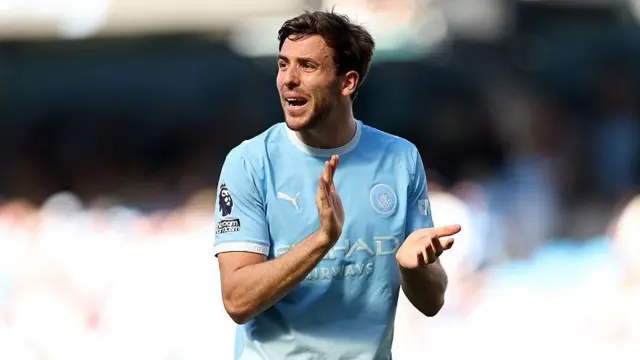 Nico Gonzalez applauds while in action for Manchester City