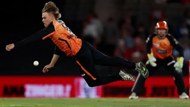 Cooper Connolly of the Scorchers dives for the ball during the BBL match between Melbourne Renegades and Perth Scorchers at Marvel Stadium