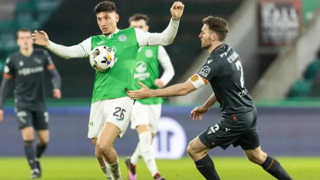 Hibernian’s Nectar Triantis (L) and Motherwell's Stephen O'Donnell in action during a William Hill Premiership match between Hibernian and Motherwell at the Easter Road 