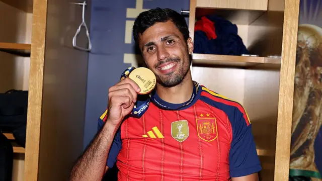 Spain midfielder Rodri poses with his World Cup medal