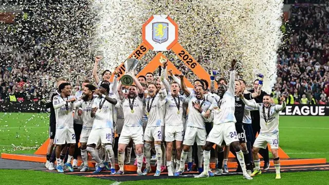 Aston Villa players celebrate with the trophy 