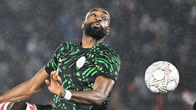 Semi Ajayi heading the ball for Nigeria against Mozambique