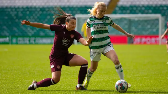 Celtic's Murphy Agnew and Hearts' Carly Girasoli in action during a Scottish Women's Premier League match between Celtic and Heart of Midlothian at Celtic Park