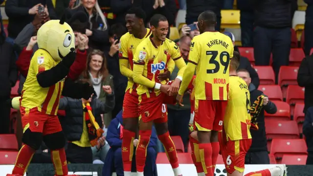Watford players and mascot celebrating a winning goal against Norwich City at Vicarage Road. 