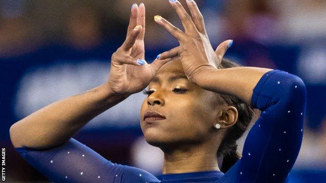 Gymnast Nia Dennis performed a routine to a medley of Beyonce music