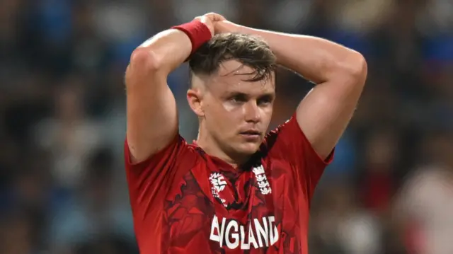 Sam Curran with his hands on his head