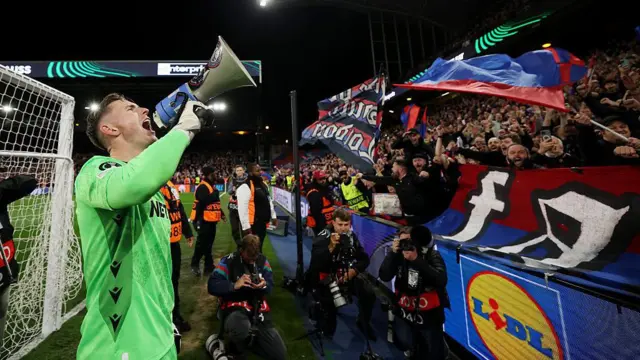Dean Henderson of Crystal Palace celebrates with a megaphone from the crowd .
