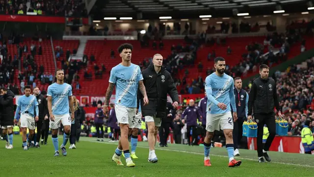 Manchester City players Nico O'Reilly, Erling Haaland, Nathan Ake andRayan Ait-Nouri look dejected after losing against Manchester United 
