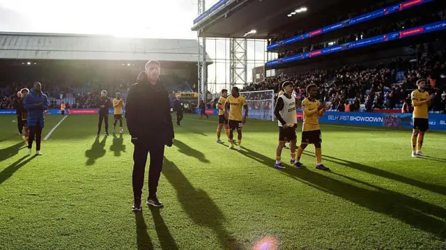 Rob Edwards and Wolves' players acknowledge their fans after defeat at Crystal Palace