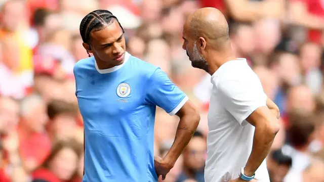 Leroy Sane talks with Pep Guardiola when he played for Manchester City in 2019