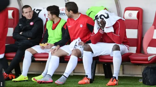 Hamilton's Christian Nade (right) is overcome with emotion after the minute's silence