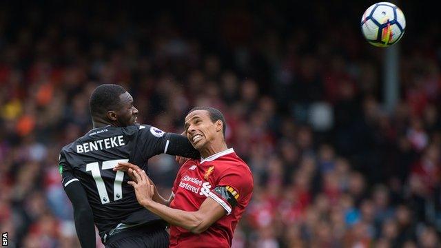 Christian Benteke and Joel Matip challenge for the ball