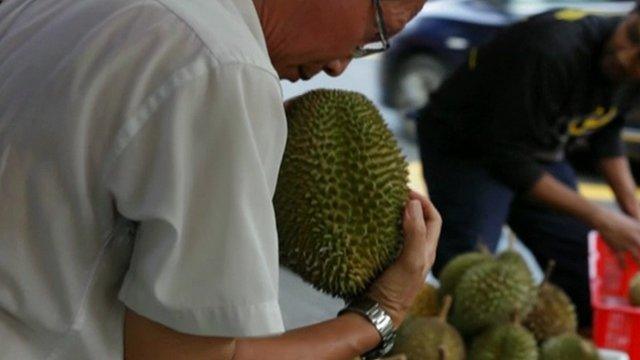 Man holds durian