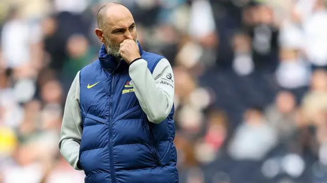 Igor Tudor with his hand on his face - the crowd is out of focus in the background