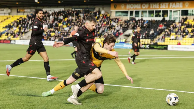 St Mirren's Scott Tanser challenges Livingston's Daniel Finlayson.